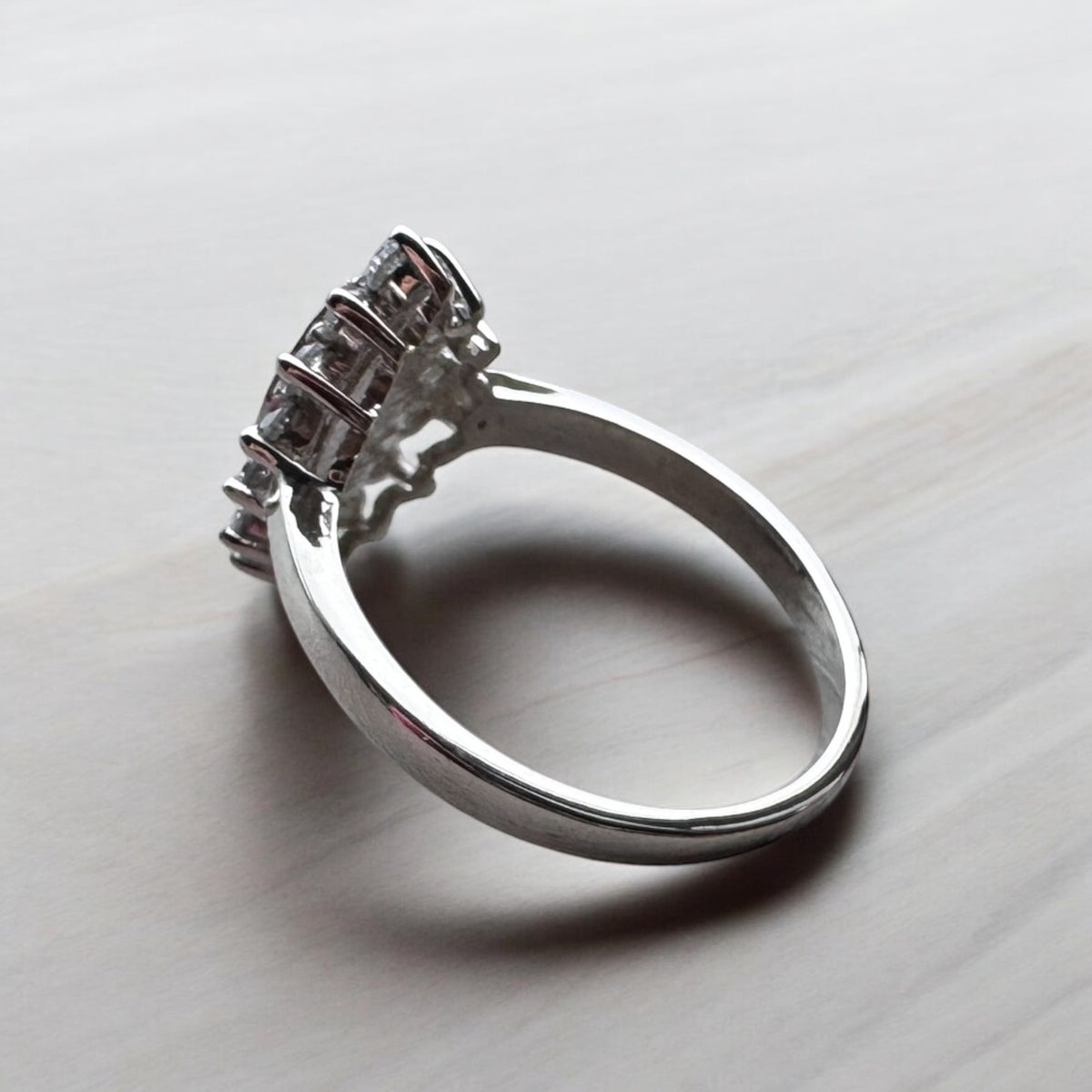 Rear view of a sterling silver halo marquise ring showing the underside of the setting and band.