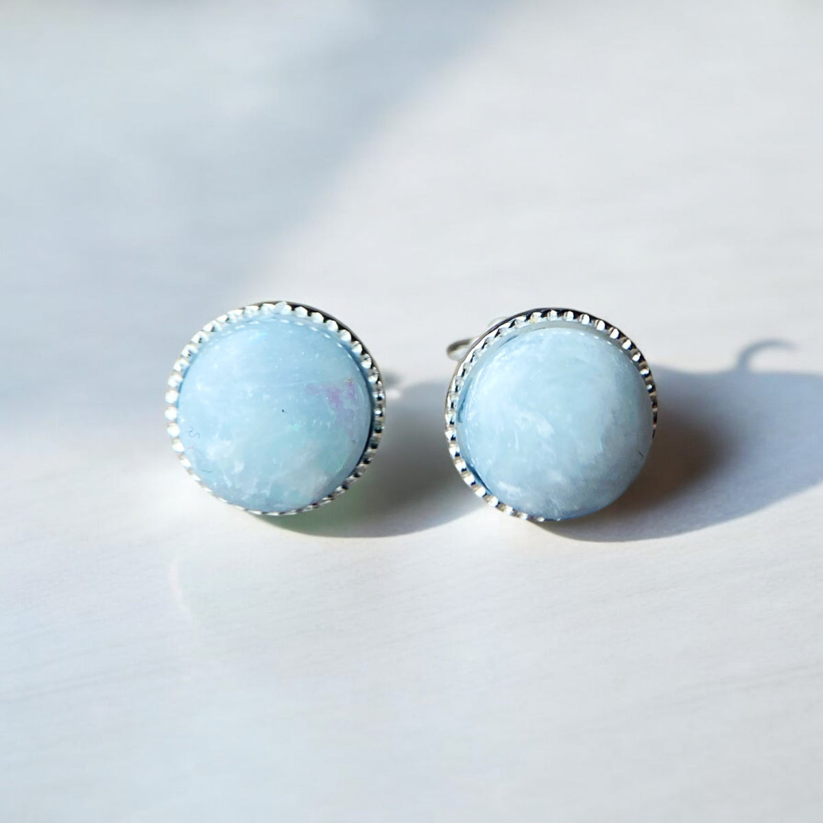 Sterling silver 8mm keepsake earrings featuring personalised resin settings with breastmilk, umbilical cord, hair and fur or placenta