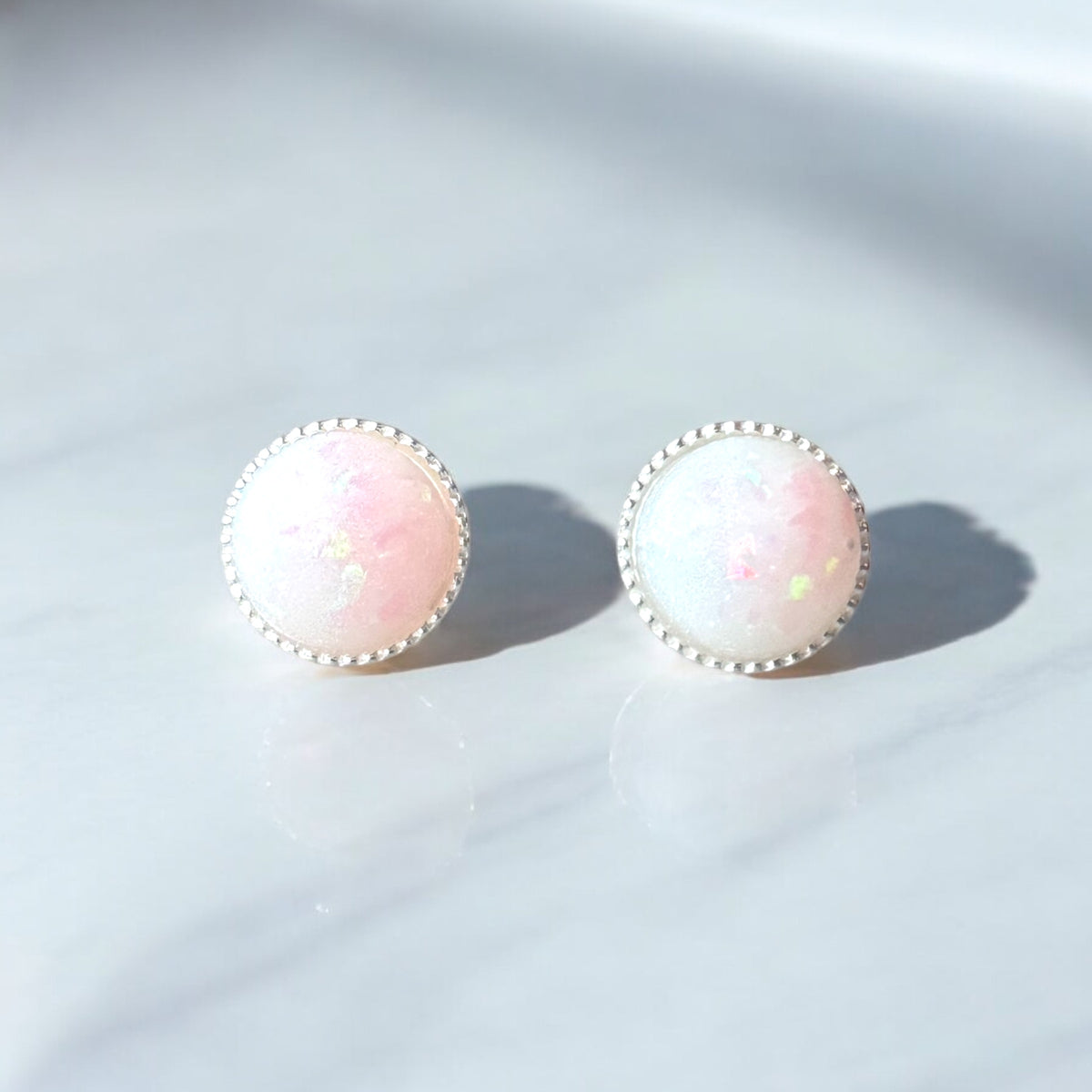 Sterling silver 8mm keepsake earrings featuring personalised resin settings with breastmilk, umbilical cord, hair and fur or placenta