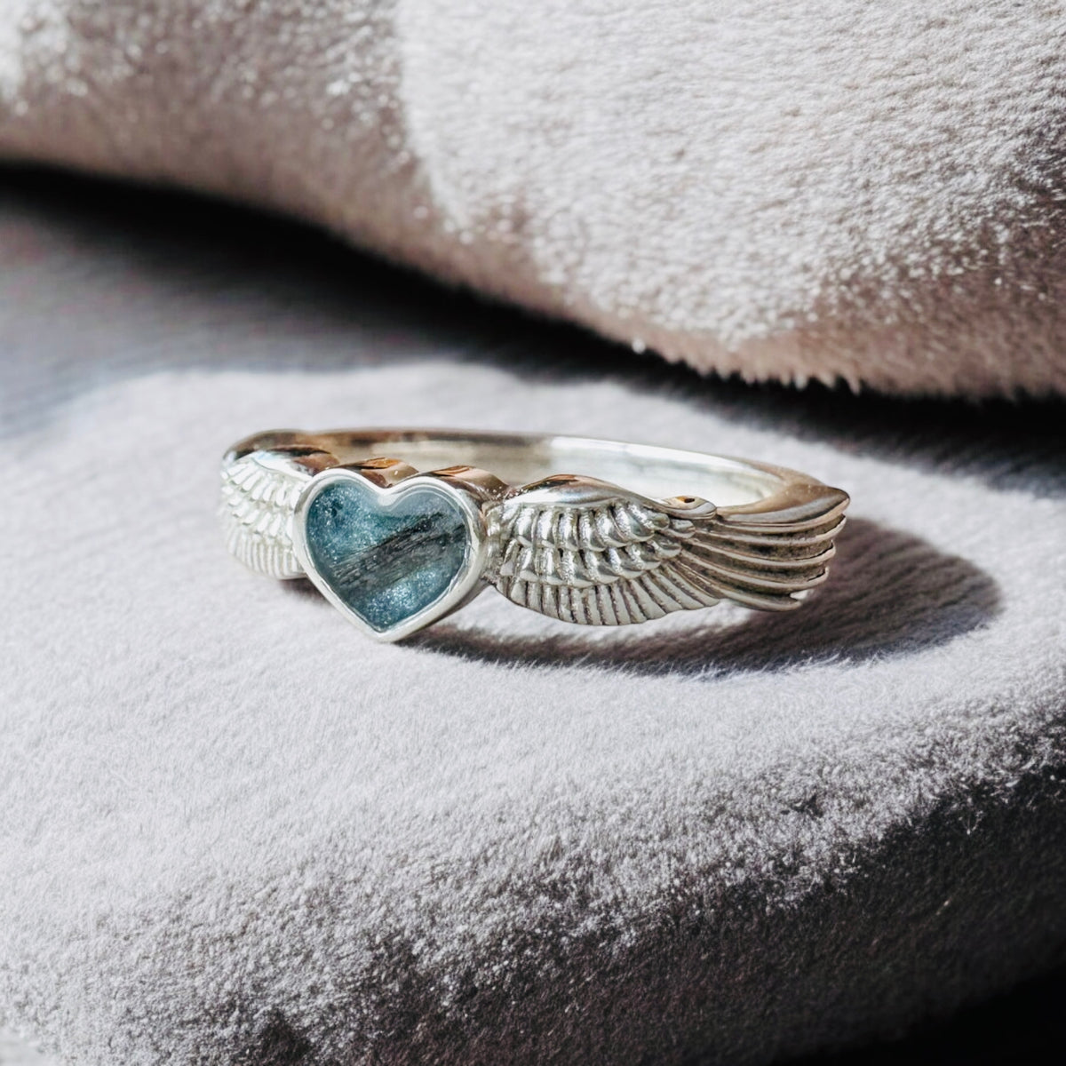 Sterling silver angel wings memorial keepsake ring, personalised with cremation ashes, breastmilk, umbilical cord, hair or pet fur. A meaningful design symbolising love, remembrance and protection. Handcrafted in West Wales by Afallon DNA Jewellery.