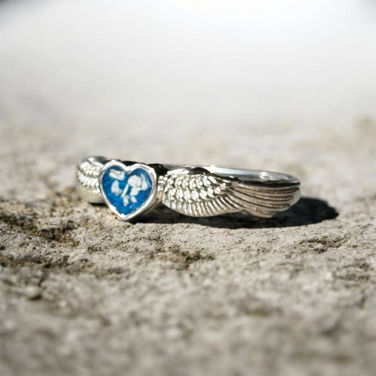 Sterling silver angel wings memorial keepsake ring, personalised with cremation ashes, breastmilk, umbilical cord, hair or pet fur. A meaningful design symbolising love, remembrance and protection. Handcrafted in West Wales by Afallon DNA Jewellery.