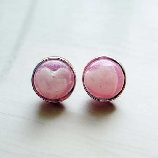 Pair of sterling silver 8mm stud earrings with pale pink hearts made from breastmilk  set inside translucent pink resin.