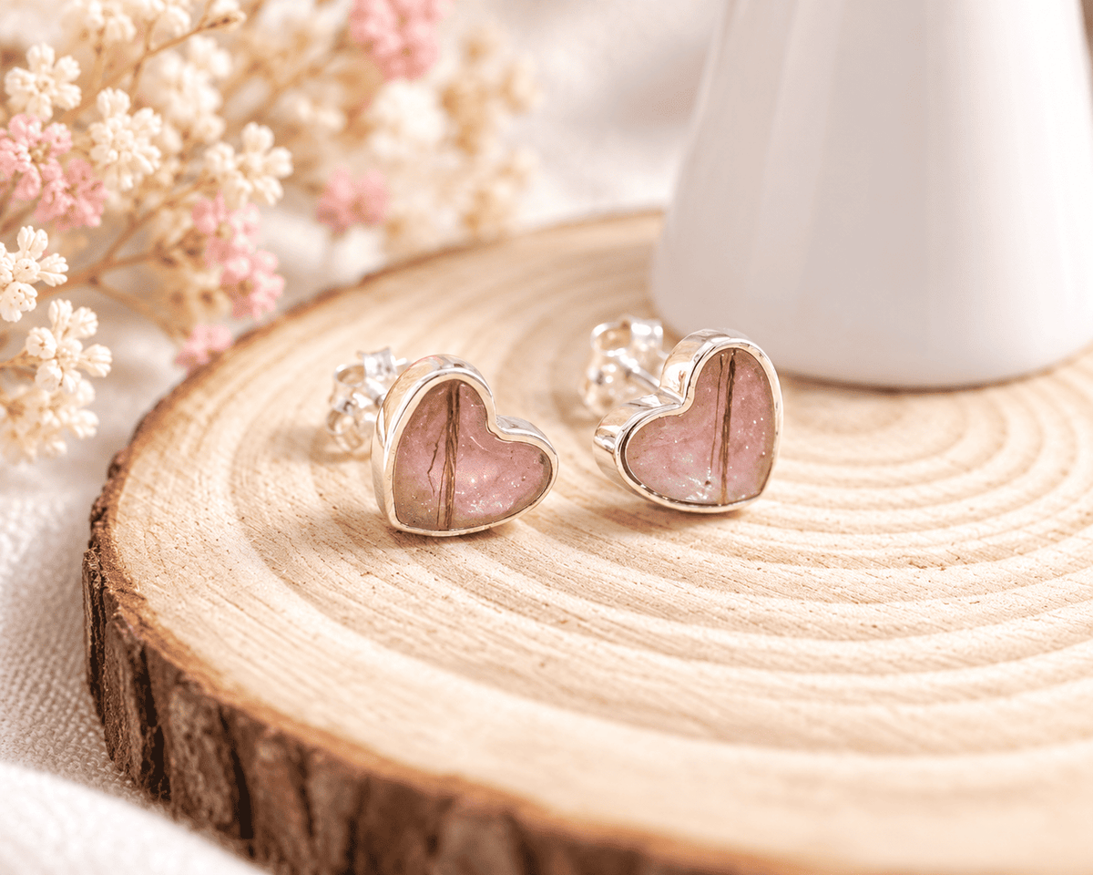 Beautiful sterling silver heart keepsake earrings, personalised with breastmilk, cremation ashes, umbilical cord, hair or pet fur. Delicate heart-shaped designs, handcrafted in West Wales by Afallon DNA Jewellery.