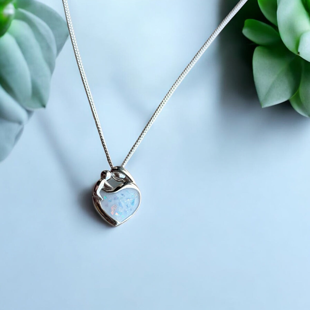 Sterling silver Mother's Love keepsake necklace, personalised with breastmilk, umbilical cord, cremation ashes, hair or pet fur. A beautiful sentimental pendant celebrating the bond between mother and child. Handcrafted in West Wales by Afallon DNA Jewellery.