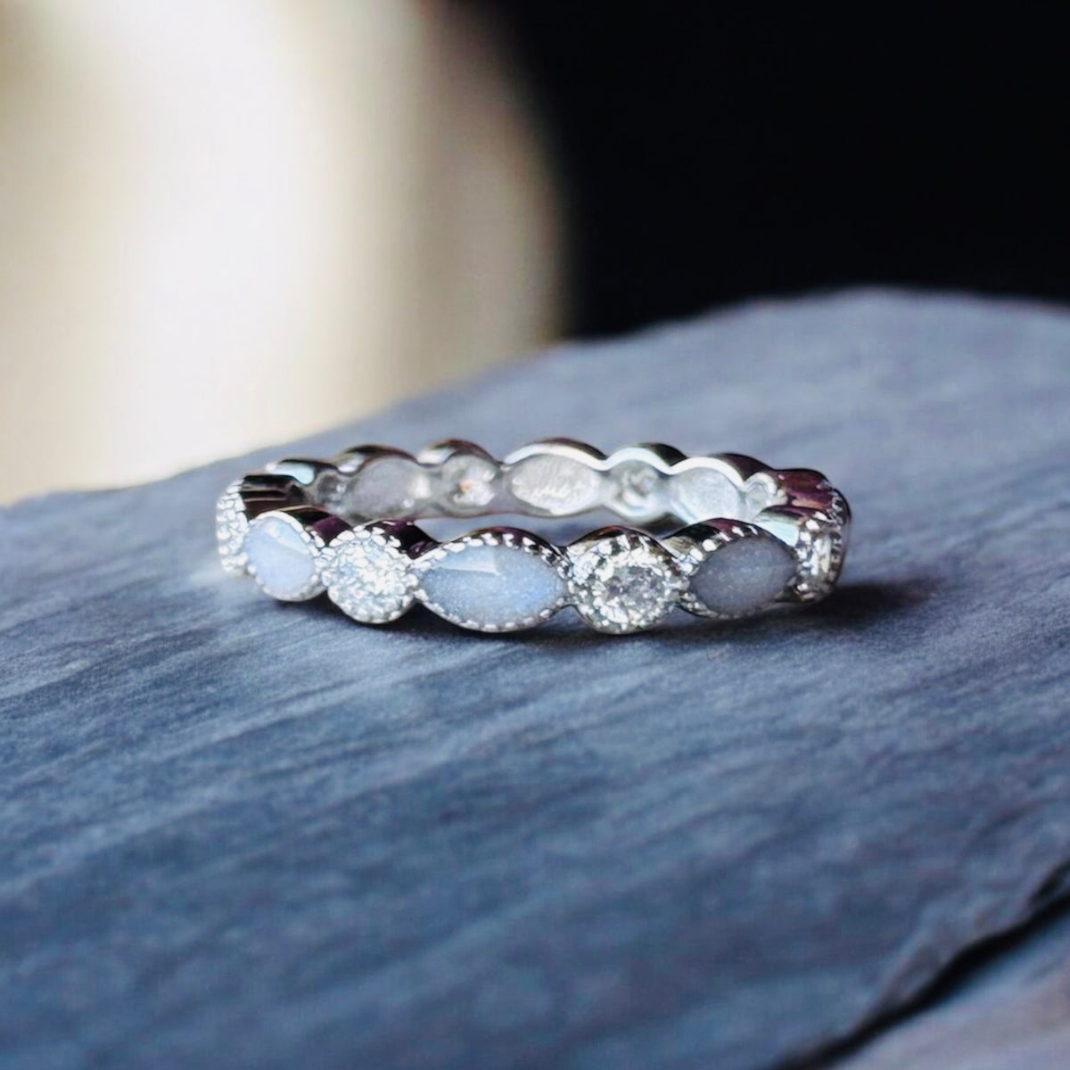 Sterling silver serrated-edge full crystal eternity keepsake ring with personalised resin settings for breastmilk, cremation ashes, hair or other precious inclusions.