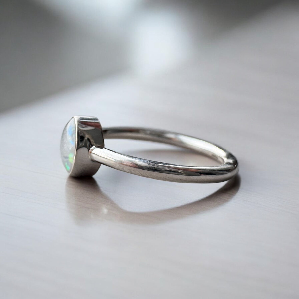 Elegant sterling silver oval keepsake ring, personalised with breastmilk, cremation ashes, umbilical cord, hair or pet fur. A timeless, minimalist design handcrafted in West Wales by Afallon DNA Jewellery.