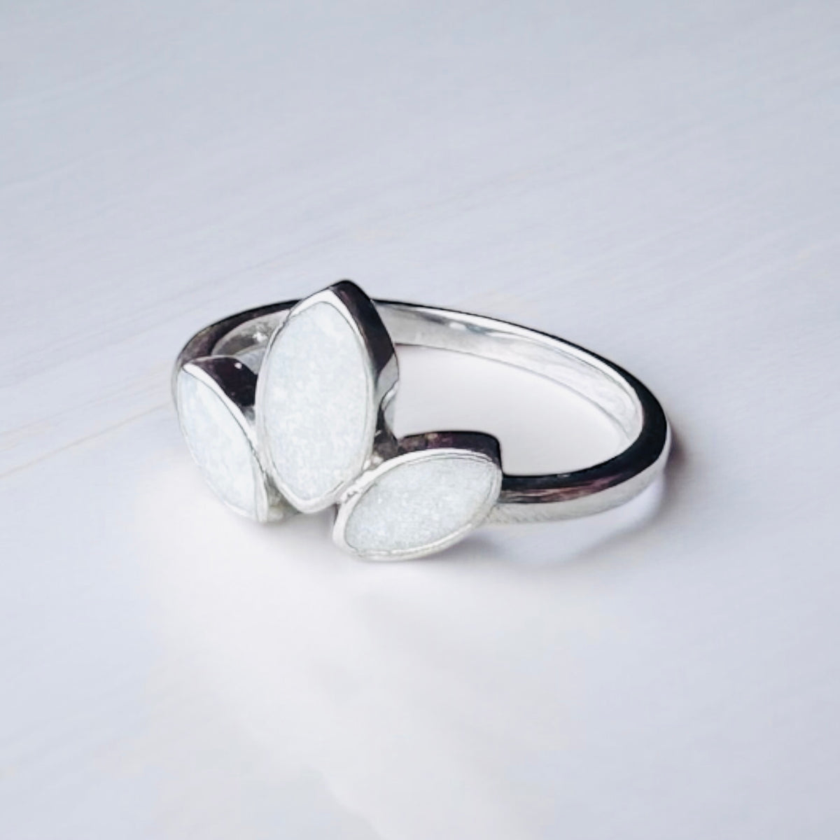 Sterling silver three marquise keepsake ring, featuring three elegant marquise-shaped settings personalised with breastmilk, cremation ashes, umbilical cord, hair or pet fur. Handcrafted in West Wales by Afallon DNA Jewellery.