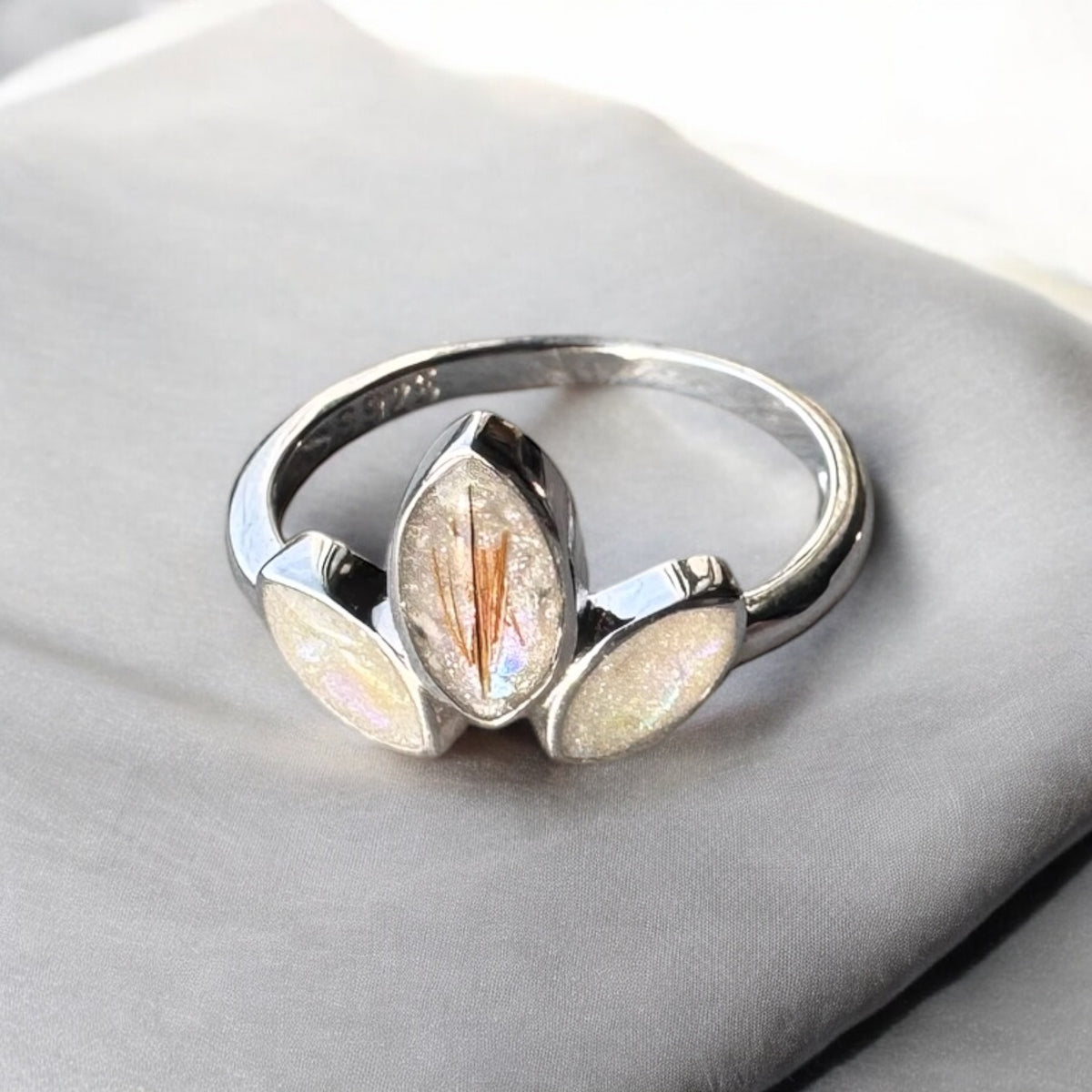 Sterling silver three marquise keepsake ring, featuring three elegant marquise-shaped settings personalised with breastmilk, cremation ashes, umbilical cord, hair or pet fur. Handcrafted in West Wales by Afallon DNA Jewellery.